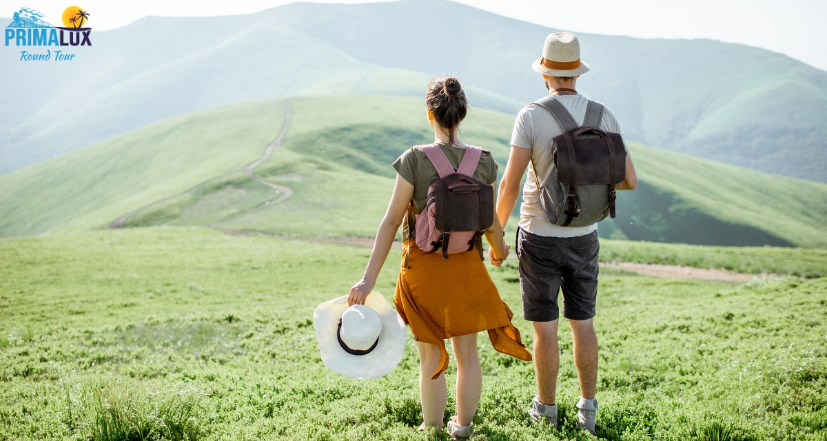 Couple hiking in green hills