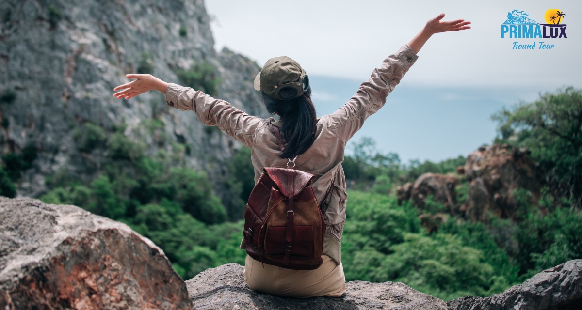 Woman with arms outstretched on a mountain